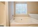Bathroom with a soaking tub and a large, bright window at 5827 Highgrove Dr, Atlanta, GA 30349