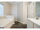 Relaxing bathroom featuring a soaking tub and modern wood-look flooring at 5827 Highgrove Dr, Atlanta, GA 30349