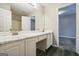 Bathroom with dual sinks, vanity area, and a full-sized mirror at 5827 Highgrove Dr, Atlanta, GA 30349