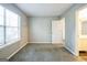 Neutral bedroom with carpet and a door leading to the bathroom at 5827 Highgrove Dr, Atlanta, GA 30349