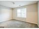 Cozy bedroom with neutral tones, soft carpet, and a bright window at 5827 Highgrove Dr, Atlanta, GA 30349