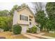 Two-story home with an inviting front porch, attached garage, black shutters, and tasteful landscaping at 5827 Highgrove Dr, Atlanta, GA 30349