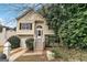 Charming two-story home featuring a welcoming entrance, well-kept lawn, and attached one car garage at 5827 Highgrove Dr, Atlanta, GA 30349