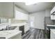 Bright kitchen featuring stainless steel appliances, white cabinets, gray walls, and vinyl flooring at 5827 Highgrove Dr, Atlanta, GA 30349