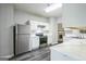 Well-lit kitchen featuring stainless steel appliances, white cabinets, gray walls, and contemporary vinyl flooring at 5827 Highgrove Dr, Atlanta, GA 30349