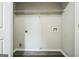 A utility room includes white shelving, hookups, and vinyl flooring at 5827 Highgrove Dr, Atlanta, GA 30349