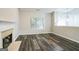 Cozy living room with hardwood floors, fireplace, large window, and a charming chandelier at 5827 Highgrove Dr, Atlanta, GA 30349