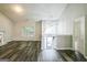 Bright living room with hardwood flooring, large window, fireplace, and access to the upper-level stairs at 5827 Highgrove Dr, Atlanta, GA 30349