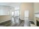 Open-concept living room featuring vinyl flooring, a fireplace, and smooth, neutral-colored walls at 5827 Highgrove Dr, Atlanta, GA 30349