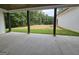 Covered back porch with concrete floor overlooking a large backyard with mature trees at Lot C Montannas Way, Moreland, GA 30259