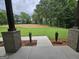 Picturesque backyard view features a spacious lawn with verdant trees, and brick support structures at Lot C Montannas Way, Moreland, GA 30259
