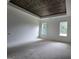 Spacious bedroom featuring a tray ceiling with wood plank detail and large windows for natural light at Lot C Montannas Way, Moreland, GA 30259