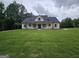 Stunning white farmhouse with black roof and an inviting front porch at Lot C Montannas Way, Moreland, GA 30259