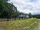 Beautiful property featuring a black wooden fence and a glimpse of the house at Lot C Montannas Way, Moreland, GA 30259