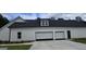 Home exterior featuring an attached garage with automated doors, and side window at Lot C Montannas Way, Moreland, GA 30259