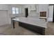 Bright kitchen featuring a large island with white countertops and ample cabinet space at Lot C Montannas Way, Moreland, GA 30259