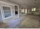 Unfinished living room with fireplace, showcasing a spacious area with ample natural light from multiple windows at Lot C Montannas Way, Moreland, GA 30259