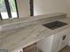 Wet bar featuring countertop with undermount sink and white cabinets at Lot C Montannas Way, Moreland, GA 30259