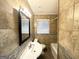 Well-lit bathroom featuring tiled walls, a modern vanity, and a shower-tub combo at 2634 Rockcliff Se Rd, Atlanta, GA 30316