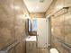 Bathroom featuring tiled walls, a window, vanity, and towel rack at 2634 Rockcliff Se Rd, Atlanta, GA 30316