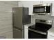 Close-up of stainless steel appliances and white cabinetry in a renovated kitchen, very modern at 3083 Colonial Way # N, Atlanta, GA 30341