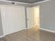 Neutral-toned bedroom with wood-look floors, and access to closet and hallways at 3083 Colonial Way # N, Atlanta, GA 30341