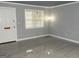 Inviting living area featuring stylish floors, white trim, a bright window, and a white front door at 3083 Colonial Way # N, Atlanta, GA 30341