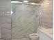 Modern bathroom featuring a glass shower, white toilet, and tiled walls at 3083 Colonial Way # N, Atlanta, GA 30341