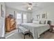 Cozy bedroom with a gray bed, a wooden dresser, and a ceiling fan for comfort at 100 Rockland Trl, Sharpsburg, GA 30277