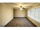 A carpeted living room featuring a ceiling fan, a window with blinds, and neutral-colored walls at 3403 Dodson Ter, East Point, GA 30344