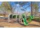 Community playground with a climbing structure and swings at 7249 Misty Harbor Ct, Stone Mountain, GA 30087