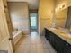 Bright bathroom featuring a double vanity, a tub, and tile flooring at 5725 Cedar Pass, Fairburn, GA 30213