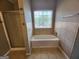 Bathroom featuring a shower with glass door, a tub and tiled walls at 5725 Cedar Pass, Fairburn, GA 30213