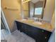 Bathroom featuring double sinks with granite counters and dark cabinetry at 5725 Cedar Pass, Fairburn, GA 30213
