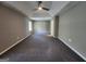 Spacious bedroom with gray carpet, neutral walls, and a modern ceiling fan at 5725 Cedar Pass, Fairburn, GA 30213