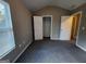 Neutral-toned bedroom featuring gray carpet, a closet, and a window for natural light at 5725 Cedar Pass, Fairburn, GA 30213
