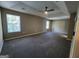 Large bedroom featuring gray carpet, neutral walls, and natural light from two windows at 5725 Cedar Pass, Fairburn, GA 30213