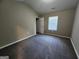 Bedroom with neutral walls, carpet floors, and a bright window at 5725 Cedar Pass, Fairburn, GA 30213