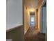 Hallway with neutral walls and carpet leads to multiple rooms in the home at 5725 Cedar Pass, Fairburn, GA 30213