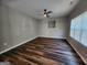 Spacious living room featuring modern ceiling fan, neutral walls and wood look floors at 5725 Cedar Pass, Fairburn, GA 30213