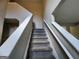 Carpeted stairway with white railing leads to the upper level of the home at 5725 Cedar Pass, Fairburn, GA 30213