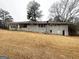 Backyard of home with a gray brick exterior on a partially wooded lot at 3820 Union Sw Rd, College Park, GA 30349