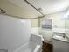 Clean bathroom with a combined shower and tub, white tile, and granite countertop at 3820 Union Sw Rd, College Park, GA 30349