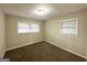 Neutral-toned bedroom featuring plush carpeting and natural light from two windows at 3820 Union Sw Rd, College Park, GA 30349
