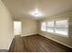 Cozy bedroom with hardwood floors, neutral paint, and natural light from the window at 3820 Union Sw Rd, College Park, GA 30349