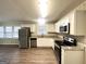 Bright kitchen featuring white cabinetry, stainless steel appliances, and granite countertops at 3820 Union Sw Rd, College Park, GA 30349