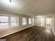 Inviting living room with hardwood floors, neutral walls, and several windows at 3820 Union Sw Rd, College Park, GA 30349