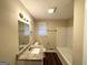 Updated bathroom featuring a granite vanity, a well-lit mirror, and a shower-tub combo at 4954 Springbrook Dr, Douglasville, GA 30135