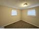 Inviting bedroom featuring carpeted floors, neutral walls, and ample natural light through two windows at 4954 Springbrook Dr, Douglasville, GA 30135