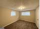 Comfortable bedroom with carpet, natural light from a large window, and neutral color palette at 4954 Springbrook Dr, Douglasville, GA 30135